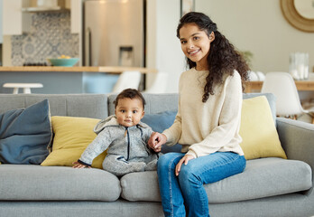 Sticker - Hes the sweetest little boy. Shot of a young mother bonding with her baby boy on the sofa at home.