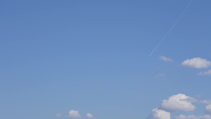 Wall Mural - airplane flying in blue sky among clouds. morning sunny sunrise blue sky with fluffy white clouds fl