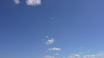 Wall Mural - beautiful early morning sunny sunrise blue sky with fluffy white clouds flying overhead in clear blu