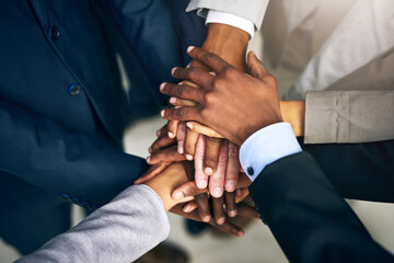 Leinwandbilder - Bring it in, team. High angle shot of a group of unrecognizable businesspeople joining their hands together in unity.