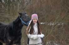 Girl In Winter With A Horse In The Paddock