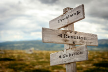 Problem Reaction Solution Text Quote Written In Wooden Signpost Outdoors In Nature. Moody Theme Feeling.