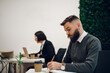 © Zamrznuti tonovi - Handsome businessman sitting at his desk in the office