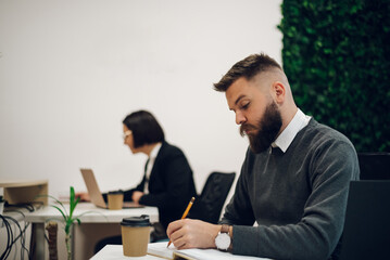 Wall Mural - Handsome businessman sitting at his desk in the office