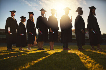 Poster - Let new adventures begin. Shot of a group of university students standing together on graduation day.