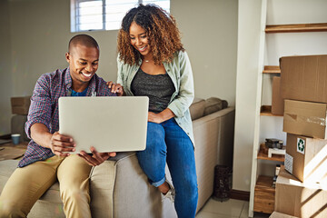 Poster - What do you think of this color for the walls. Shot of a cheerful young couple doing online shopping together while being seated on a couch at home.