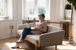 © fizkes - Older woman sit on sofa with laptop greets friend, relative, grown up children make video call use videoconference app. Easy comfort tech usage, remote communication, on-line counselling event concept