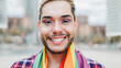 Gay man with makeup on wearing rainbow flag outdoor - LGBTQ drag queen concept