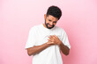 © luismolinero - Young Brazilian man isolated on pink background having a pain in the heart