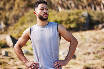 Canvas Print - I can feel that run ache in my muscles. Shot of a handsome young man standing alone outside with his hands on his hips after a run.