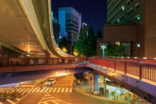 Pedestrian Overpass Over Quiet Intersection In Central Business District At Night