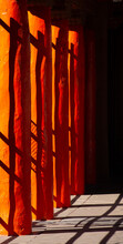 Abstract Design Of Of Black Shadows On Vibrant Orange Wooden Pillars Shadows Of Fence Cast On Pillars In Afternoon Sunlight In Down Town Santa Fe New Mexico Near Plaza Colorful Vertical Backdrop 
