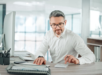 Canvas Print - Theres still some room for reinvesting. Shot of a mature businessman sitting alone in his office and calculating his finances.