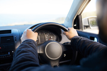 Wall Mural - You know more of a road by having traveled. Shot of a unrecognizable man driving his car.