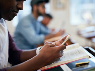 Fototapete - He loves that he can check his answers straight away. Cropped shot of university students using their smartphones in class.