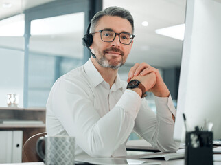 Aufkleber - Im always ready to seal some deals. Shot of a mature customer service agent sitting alone in the office and using his computer.