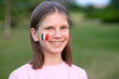 © Svetlana - Happy school girl with cheek painted in Italy flag colors. Educational course, studying Italian. Italian language. Concept of abroad education. Italy football fan. Children score goal at football game