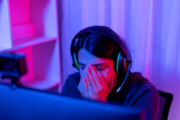 Wall Mural - Men play E-Sport games or streamers, Lost the match, Male stressed after being criticized and scolded by the audience, Technology game trends, Hurt the feelings, sadly.., Red and blue background...