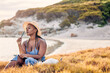 © Alexis Scholtz/peopleimages.com - Trouble knows how to swim. Shot of a young woman writing in her journal at the beach.