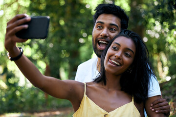 Wall Mural - Youre my kind of person. Shot of a young couple taking a selfie while out on a date.