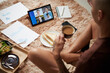 © DragonImages - Young entrepreneur eating breakfast and attending online meeting with colleagues