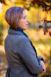© soleg - portrait of a beautiful woman posing in a city park in autumn, bright sunny day, colorful yellow leaves