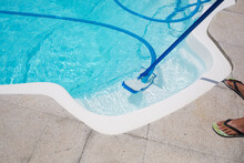Cleaning Pool With Vacuum Cleaner. Cleaning Equipment For Small Pools.