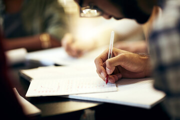 Aufkleber - This is all going to pay off soon. Shot of a group of unrecognizable people making notes on paper while being seated around a table indoors.