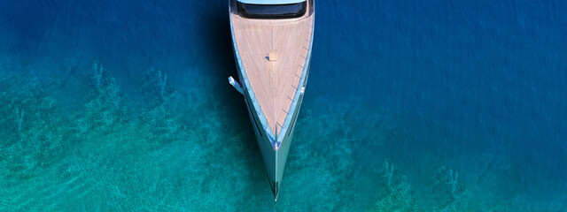 Wall Mural - Aerial drone top view ultra wide photo of large yacht anchored in tropical exotic paradise with turquoise open sea
