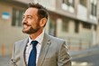 © Krakenimages.com - Middle age businessman smiling happy standing at the city.