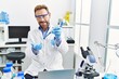 © Krakenimages.com - Middle age hispanic man wearing scientist uniform working at laboratory