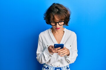 Sticker - Young brunette woman using smartphone skeptic and nervous, frowning upset because of problem. negative person.