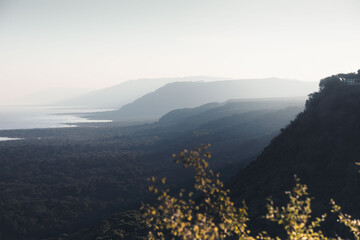 Scenir view of Manyara lake at sunset, touristic sight in tanzania, with cliffs and the national park on the foreground