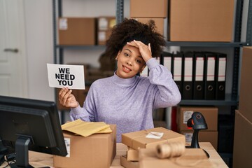 Poster - Young african american woman working at small business ecommerce holding banner stressed and frustrated with hand on head, surprised and angry face