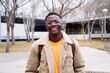 © CarlosBarquero - Close up shot of cheerful happy African American teenage boy looking at camera smiling. Intense look of a young student man at campus university high school.