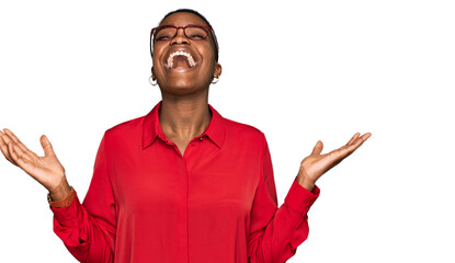 Canvas Print - Young african american woman wearing casual clothes and glasses celebrating mad and crazy for success with arms raised and closed eyes screaming excited. winner concept