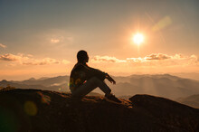 Silhouette Young Hiker Woman Relaxing And Enjoying The Sunset View On Top Of Mountain Peak At National Park