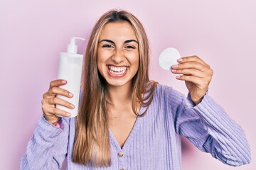 Canvas Print - Beautiful hispanic woman holding cotton pad and make up remover smiling and laughing hard out loud because funny crazy joke.