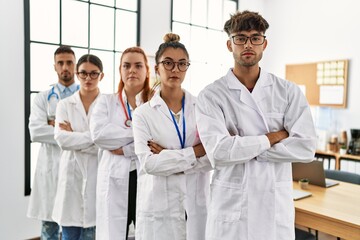 Sticker - Group of young doctor with serious expression standing with arms crossed gesture at the clinic office.