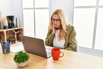 Poster - Beautiful blonde woman working at the office with laptop touching mouth with hand with painful expression because of toothache or dental illness on teeth. dentist