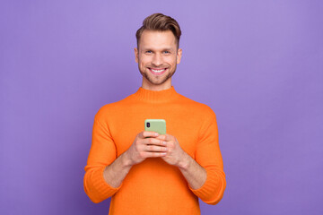 Wall Mural - Photo of good mood positive man chatting with girlfriend in cellphone gadget isolated on purple color background