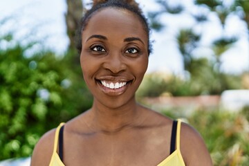 Canvas Print - Young african american woman smiling happy on a summer day