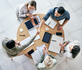 Wall Mural - we strive to become better than we are. shot of businessmen shaking hands during a team meeting in a