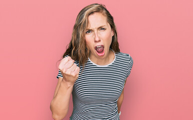 Sticker - Young blonde woman wearing casual clothes angry and mad raising fist frustrated and furious while shouting with anger. rage and aggressive concept.