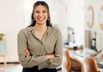 Fototapete - Its my job to make your day easier. Shot of an attractive young businesswoman standing alone in the office with her arms folded.