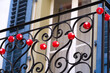 Decoration with red lampions with white Swiss cross hanging form wrought iron railing at the old town of City of Sion. Photo taken April 4th, 2022, Sion, Switzerland.