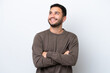 © luismolinero - Young Brazilian man isolated on white background looking up while smiling