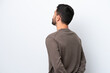 © luismolinero - Young Brazilian man isolated on white background in back position and looking back