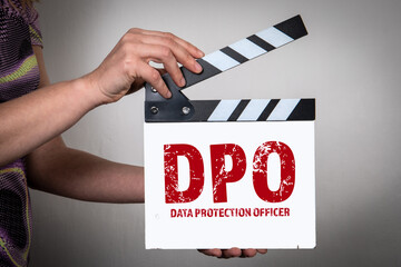 Wall Mural - DPO Data Protection Officer Concept. Female hands holding movie clapper