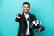 © luismolinero - Young Brazilian woman with a motorcycle helmet isolated on blue background smiling and showing victory sign